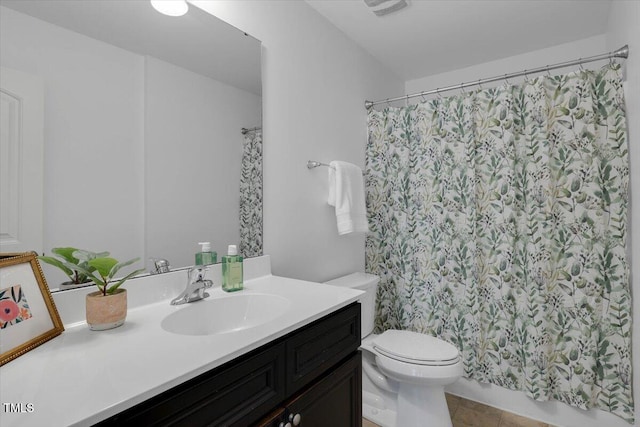 bathroom with a shower with shower curtain, toilet, vanity, and tile patterned flooring