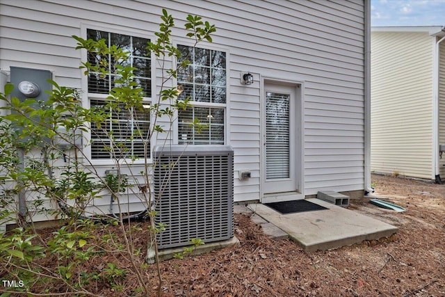 property entrance featuring central AC unit