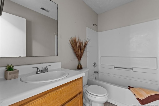 bathroom featuring visible vents, toilet, a textured ceiling,  shower combination, and vanity