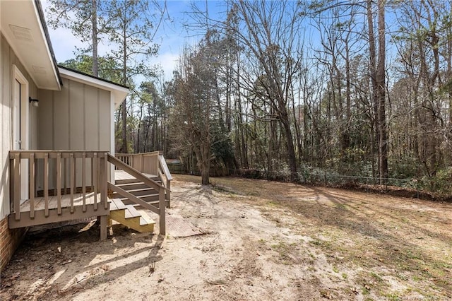 view of yard with a deck and fence