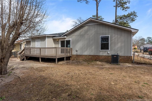 back of property featuring central AC unit, fence, and a wooden deck