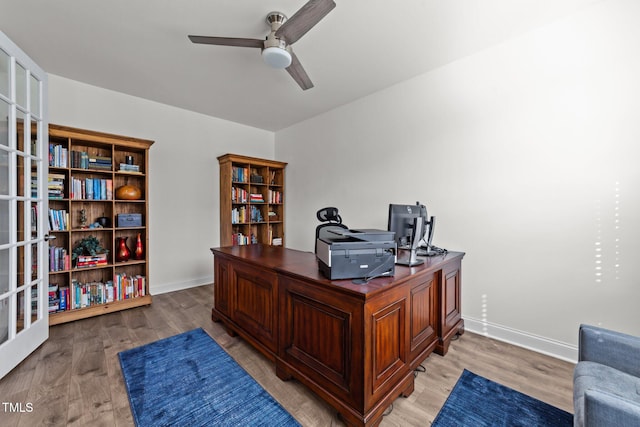 home office with light wood finished floors, french doors, baseboards, and a ceiling fan