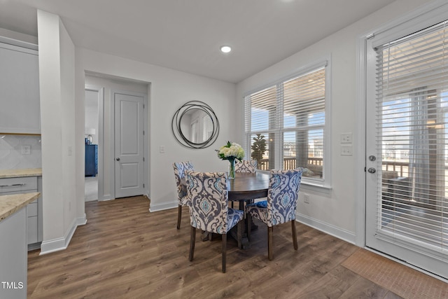 dining space with recessed lighting, baseboards, and dark wood-style flooring