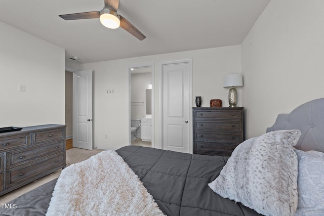 carpeted bedroom with ceiling fan, baseboards, and connected bathroom