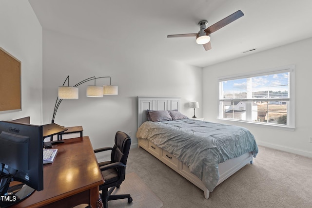 carpeted bedroom featuring visible vents, a ceiling fan, and baseboards