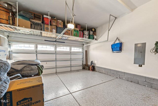 garage with electric panel and a garage door opener