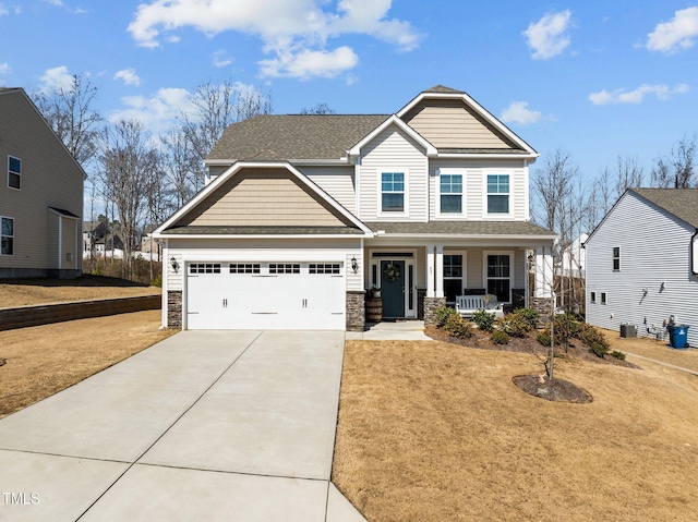 craftsman-style home featuring stone siding, a porch, concrete driveway, a shingled roof, and a garage