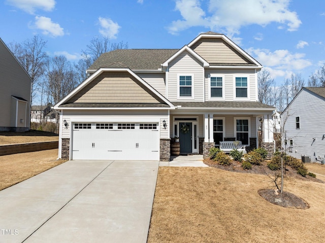 craftsman-style house featuring driveway, covered porch, a shingled roof, a garage, and stone siding