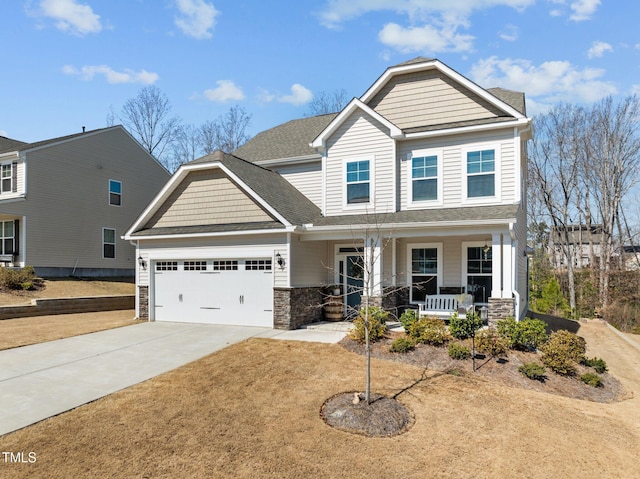 craftsman inspired home featuring driveway, stone siding, a porch, roof with shingles, and an attached garage