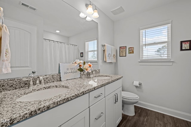 full bath featuring visible vents, toilet, baseboards, and a sink