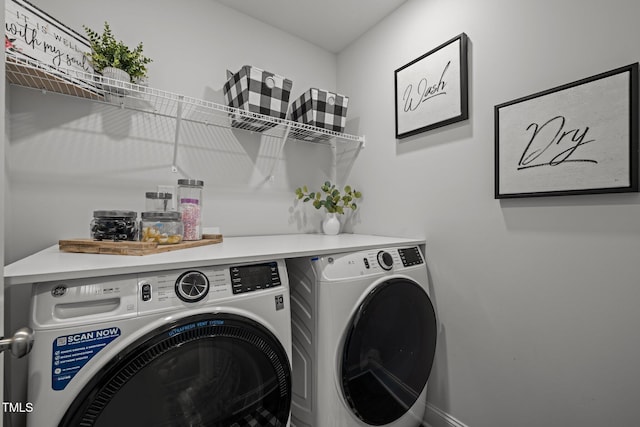 clothes washing area featuring laundry area and washing machine and clothes dryer