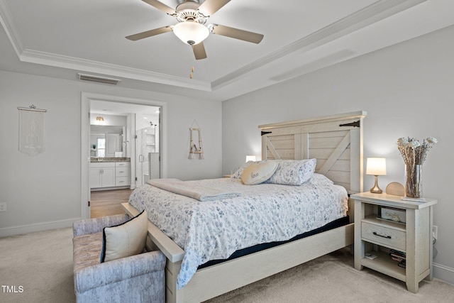 bedroom featuring visible vents, ornamental molding, a tray ceiling, baseboards, and light colored carpet