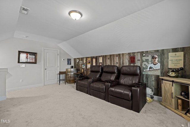 carpeted cinema room with visible vents, baseboards, and lofted ceiling