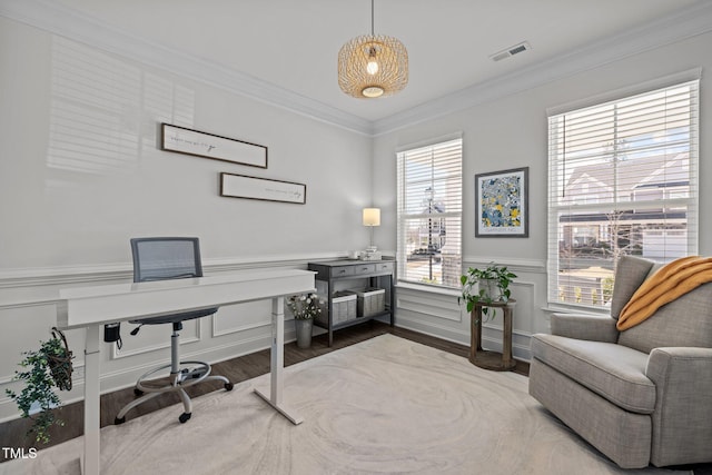 office space featuring visible vents, wood finished floors, ornamental molding, and a wainscoted wall