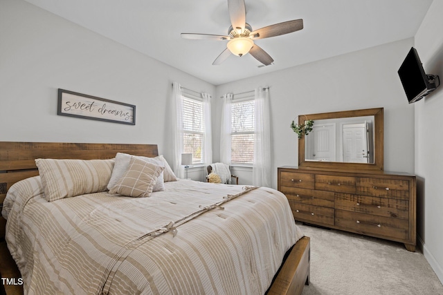 bedroom featuring baseboards, light carpet, and ceiling fan