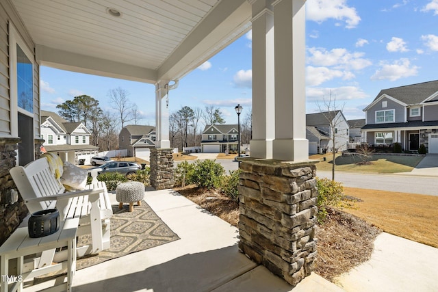 view of patio / terrace featuring a residential view and a porch