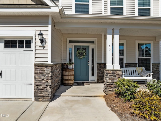 property entrance with stone siding and covered porch