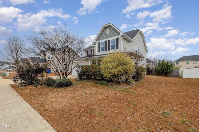 view of front of property with driveway and fence