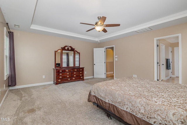 bedroom with light carpet, visible vents, a tray ceiling, and baseboards