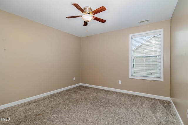 unfurnished room featuring visible vents, baseboards, carpet floors, and ceiling fan