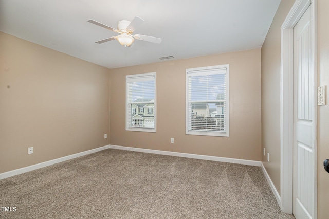 unfurnished room with visible vents, ceiling fan, baseboards, and carpet floors