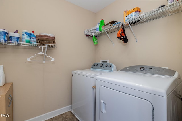 laundry room with tile patterned floors, baseboards, independent washer and dryer, and laundry area