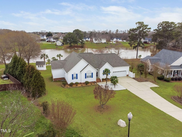 drone / aerial view featuring a water view and a residential view