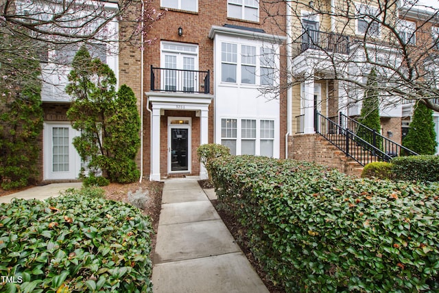 view of exterior entry with brick siding