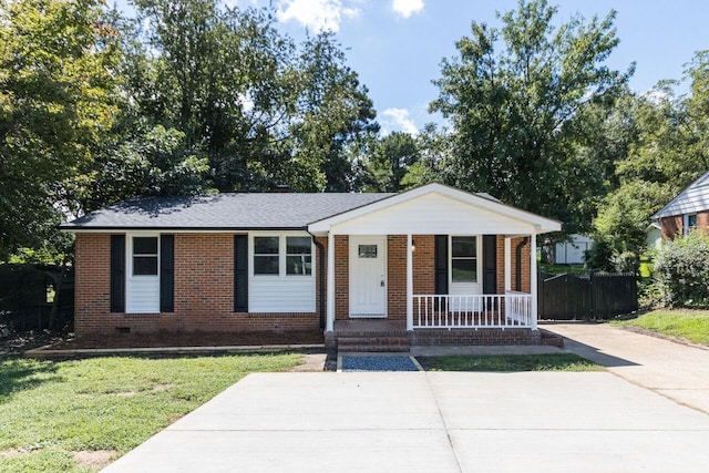 ranch-style home with crawl space, brick siding, covered porch, and a front lawn