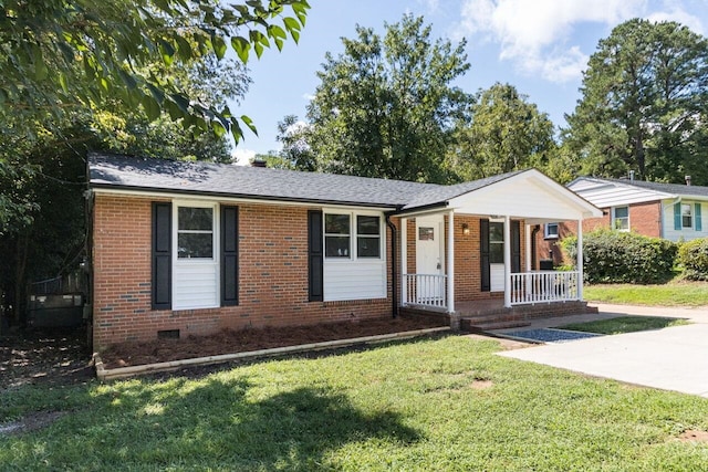 view of front facade with a porch, a shingled roof, a front lawn, crawl space, and brick siding