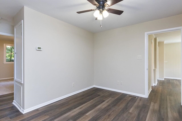 unfurnished room featuring ceiling fan, visible vents, baseboards, and dark wood-style floors