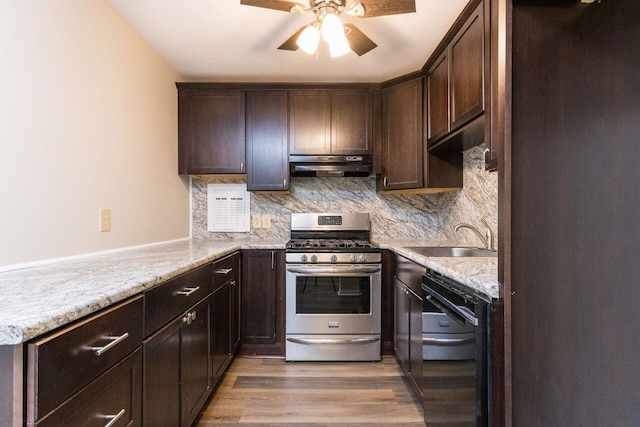 kitchen featuring under cabinet range hood, dark brown cabinetry, black dishwasher, gas stove, and a sink