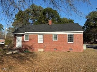 rear view of house featuring crawl space, brick siding, and a yard