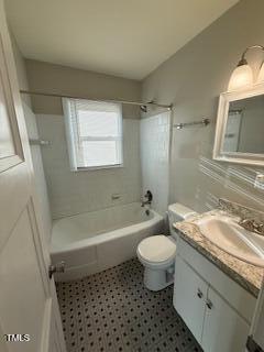 bathroom featuring vanity, shower / bathing tub combination, and toilet