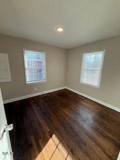 empty room with baseboards and wood finished floors