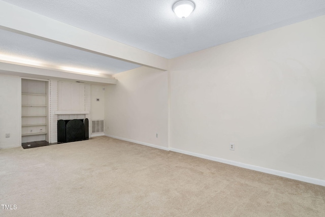 unfurnished living room featuring baseboards, visible vents, a textured ceiling, a brick fireplace, and carpet flooring