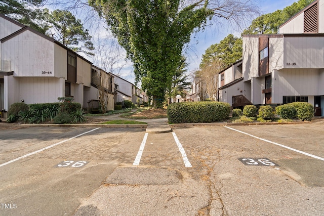 uncovered parking lot featuring a residential view