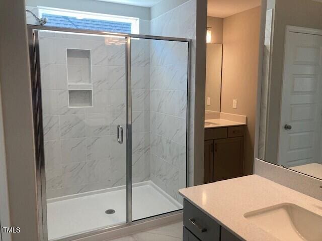 full bathroom featuring a stall shower and vanity