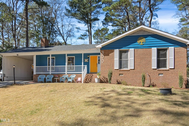 view of front facade with brick siding, a porch, a front yard, a chimney, and a carport