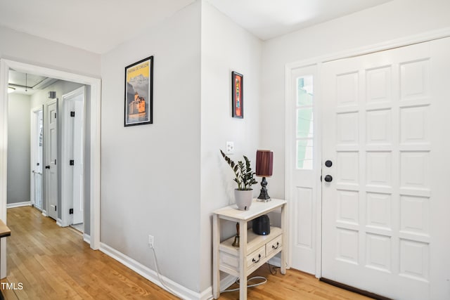 entryway featuring baseboards and light wood-style floors