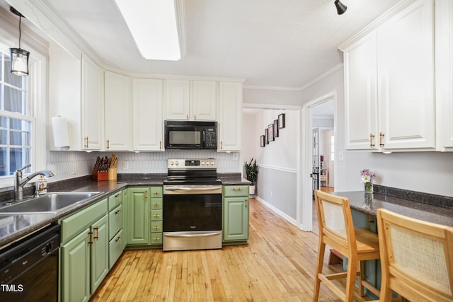 kitchen with a sink, black appliances, white cabinets, and green cabinetry