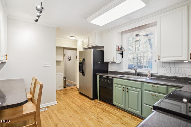 kitchen with green cabinetry, white cabinets, dishwasher, and a sink