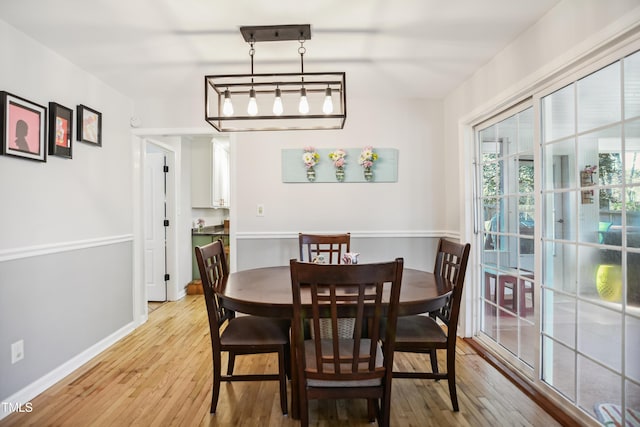 dining room with baseboards and light wood-style floors