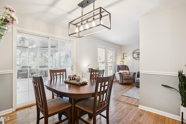 dining area featuring baseboards and light wood finished floors