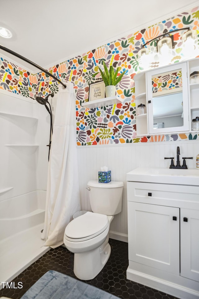 full bathroom featuring tile patterned floors, a wainscoted wall, toilet, and a stall shower