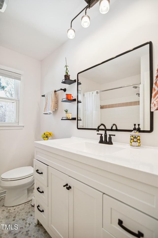 bathroom with visible vents, toilet, vanity, and a shower with curtain