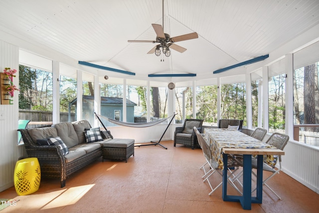 sunroom / solarium featuring vaulted ceiling, plenty of natural light, and a ceiling fan