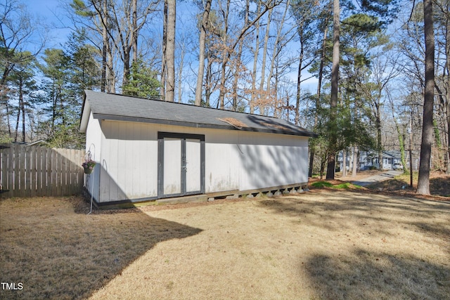 view of shed featuring fence