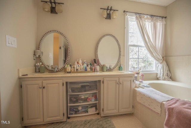 bathroom with a bath and double vanity