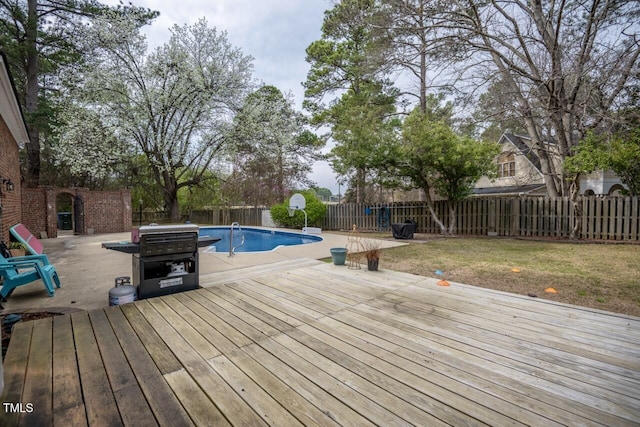 view of swimming pool featuring a deck, a fenced backyard, a fenced in pool, and grilling area